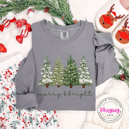 Flat lay of a Gray long sleeve tee with a snowy evergreen trees design.