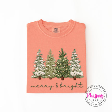 Terracotta long sleeve tee with a classic snowy Christmas trees graphic, flat lay view.