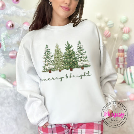 Close up of soft script lettering and trees on a White crewneck sweatshirt.
