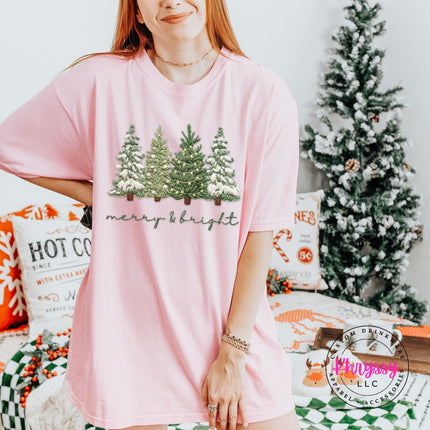 Blossom Comfort Colors tee with snowy evergreen trees and merry and bright script.