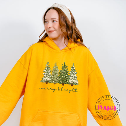 Cozy Gold hoodie styled with joggers, showing the full Christmas trees design.