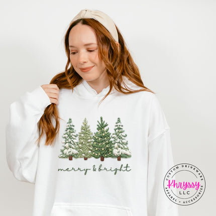 Close up of soft script lettering and trees on a White pullover hoodie.