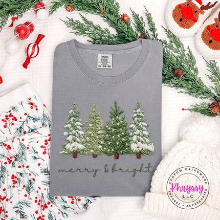 Flat lay of a Gray Comfort Colors tee with a snowy evergreen trees design.