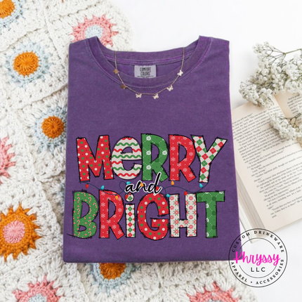 Flat lay of the Merry and Bright patterned Christmas long sleeve tee in Grape.