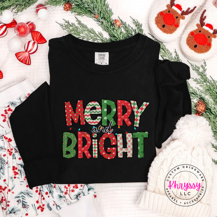 Black long sleeve tee featuring patterned Merry and Bright block letters.