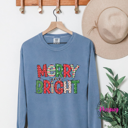 Model wearing the Merry and Bright patterned long sleeve tee in Blue Jean.