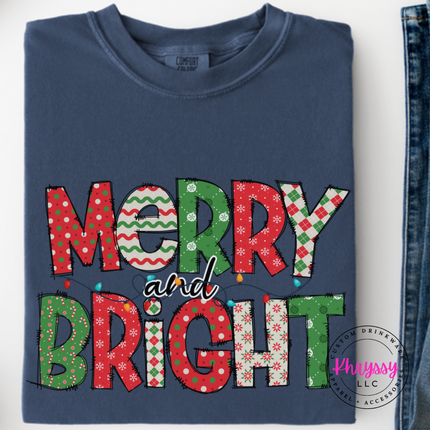Close up of the Merry and Bright patterned art on a Denim long sleeve tee.
