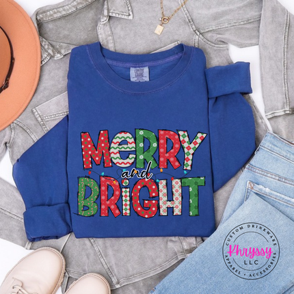 Close up of the Merry and Bright patterned art on a Navy long sleeve tee.