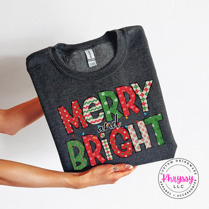 Dark Heather crewneck sweatshirt showing candy stripe and polka dot holiday letters.