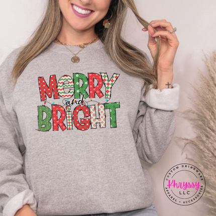 Flat lay of the Merry and Bright patterned Christmas crewneck sweatshirt in Graphite Heather.