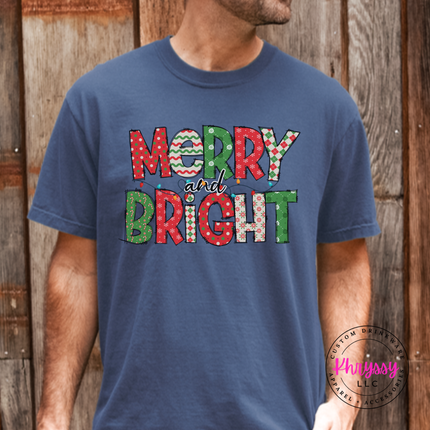 Close up of the Merry and Bright patterned art on a Denim tee.