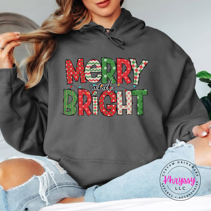 Model wearing the Merry and Bright patterned hoodie in Charcoal.