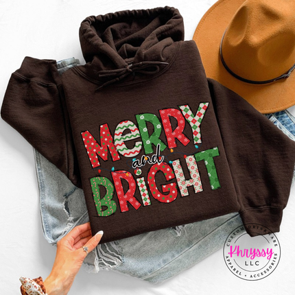 Close up of the Merry and Bright patterned art on a Dark Chocolate hoodie.