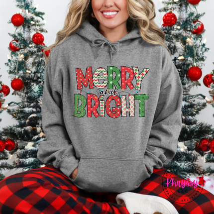 Flat lay of the Merry and Bright patterned Christmas hoodie in Graphite Heather.