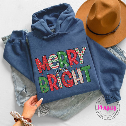 Indigo Blue hoodie featuring patterned Merry and Bright block letters.