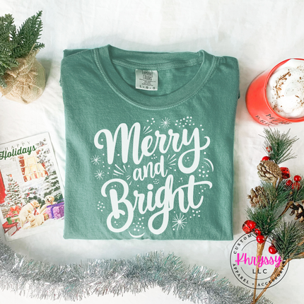 Close up of the Merry and Bright art on a Light Green tee.