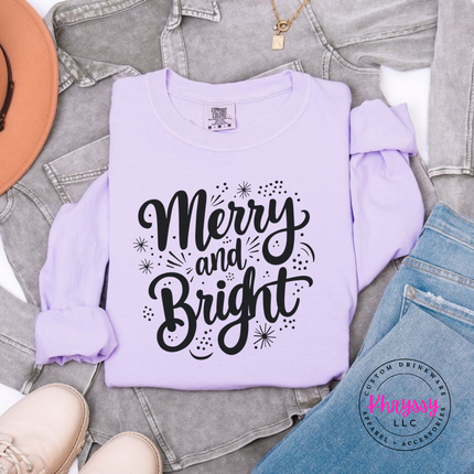 Orchid long sleeve tee showing Merry and Bright script with tiny sparkles.