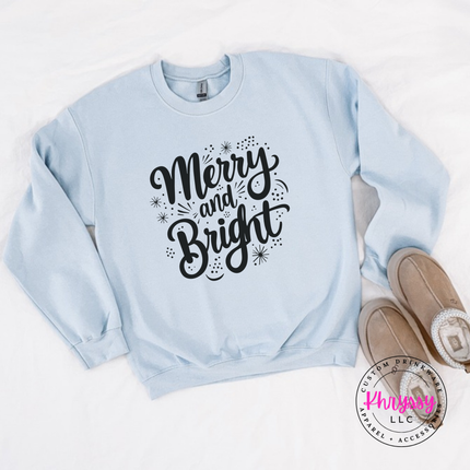 Flat lay of the Merry and Bright Christmas crewneck sweatshirt in Light Blue.