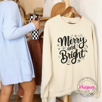 Close up of the Merry and Bright art on a Sand crewneck sweatshirt.