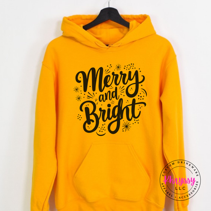 Model wearing the Merry and Bright hoodie in Gold.