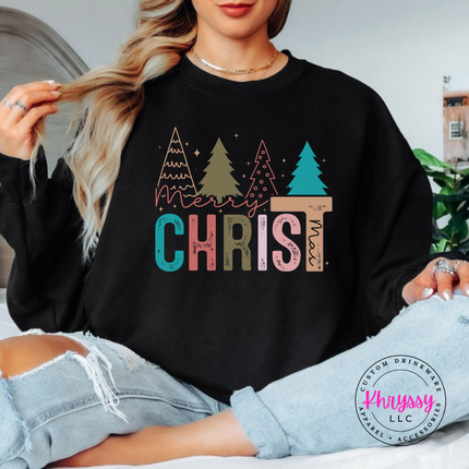 Black crewneck sweatshirt featuring Merry Christ mas lettering and colorful trees.