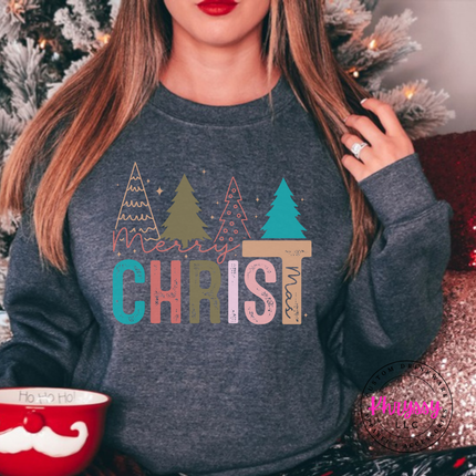 Dark Heather crewneck sweatshirt showing bold CHRIST letters under four Christmas trees.