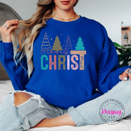 Royal crewneck sweatshirt showing bold CHRIST letters under four Christmas trees.