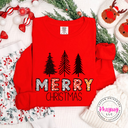 Red long sleeve tee showing three pines over glittery Merry letters.