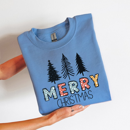 Model wearing the Merry Christmas pine crewneck sweatshirt in Carolina Blue.