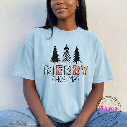 Chambray tee showing three pines over glittery Merry letters.