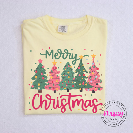 Model wearing the Merry Christmas tree tee in Butter.