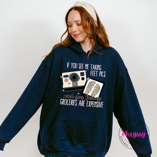 Person wearing a navy hoodie with a humorous graphic and text on a white background