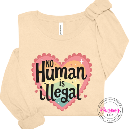 Beige long-sleeve shirt with 'No Human is Illegal' design on a white background