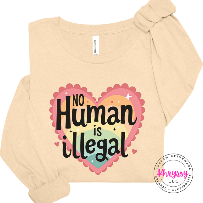 Beige long-sleeve shirt with 'No Human is Illegal' design on a white background