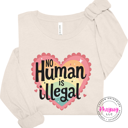 Beige long-sleeve shirt with 'No Human is Illegal' design on a white background
