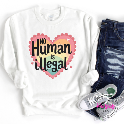 No human is illegal, white crewneck design, paired with jeans and sneakers on a white background.