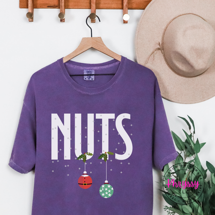 Close up of the Nuts holiday pun print on a Grape tee.