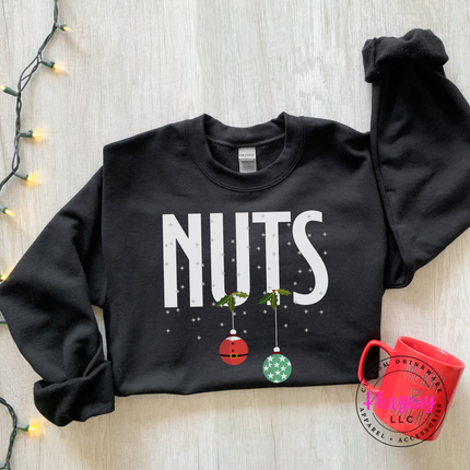 Black crewneck sweatshirt with bold Nuts lettering and two hanging ornaments.