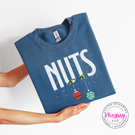 Indigo Blue crewneck sweatshirt featuring holly, snowflakes and two holiday ornaments.
