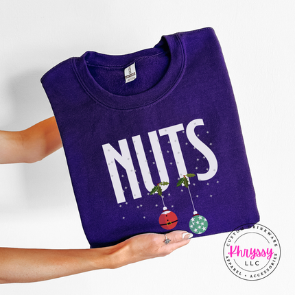 Man wearing the Nuts Christmas ornament crewneck sweatshirt in Purple.