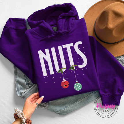 Man wearing the Nuts Christmas ornament hoodie in Purple.