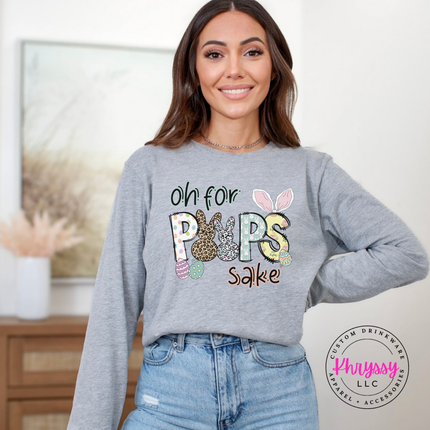Woman wearing a gray bella+canvas long sleeve shirt with colorful text and graphics, standing in a room.