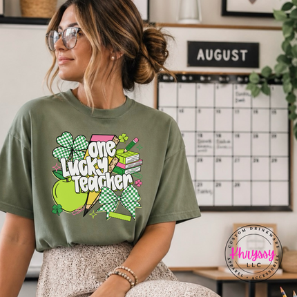 Moss green tee styled with a playful one lucky teacher graphic.