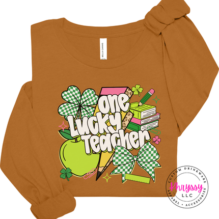 Toast tan long sleeve tee with a bright checkered shamrock teacher print.