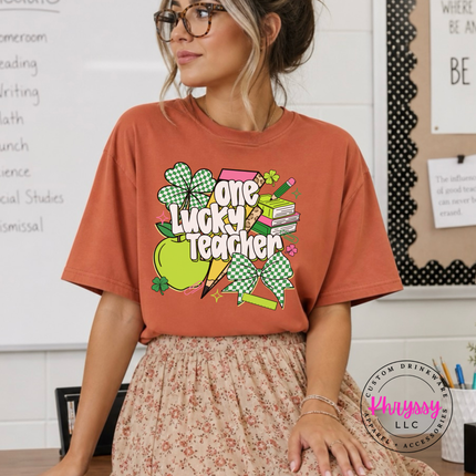 yam soft tee showing white lettering over a festive shamrock design.