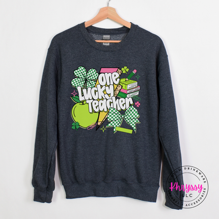 Dark heather crewneck featuring checkered shamrocks and a leopard bolt.