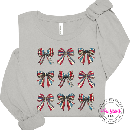 Silver long sleeve tee displaying a patriotic coquette flag-bow graphic.