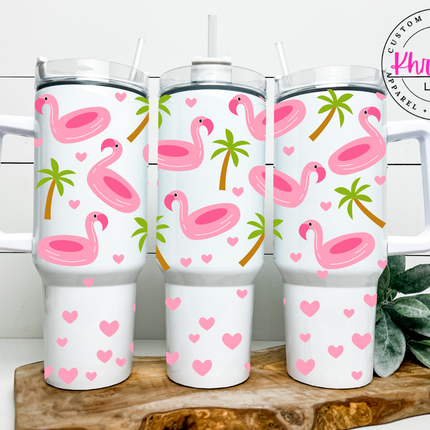 40oz stainless steel tumblers with metal straws, featuring a white background with pink flamingo and palm tree design, and a clear lid on top.