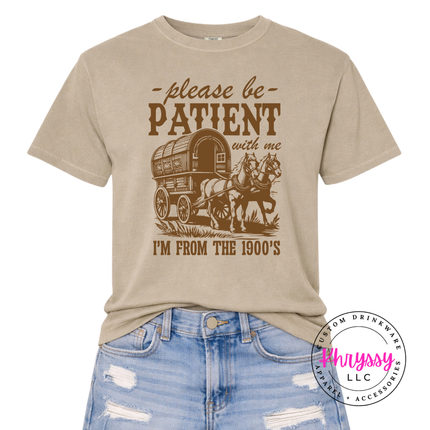 Earthy pigment-dyed humor tee with charming covered wagon illustration