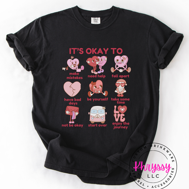 Black t-shirt with pink graphic design and text on a white background